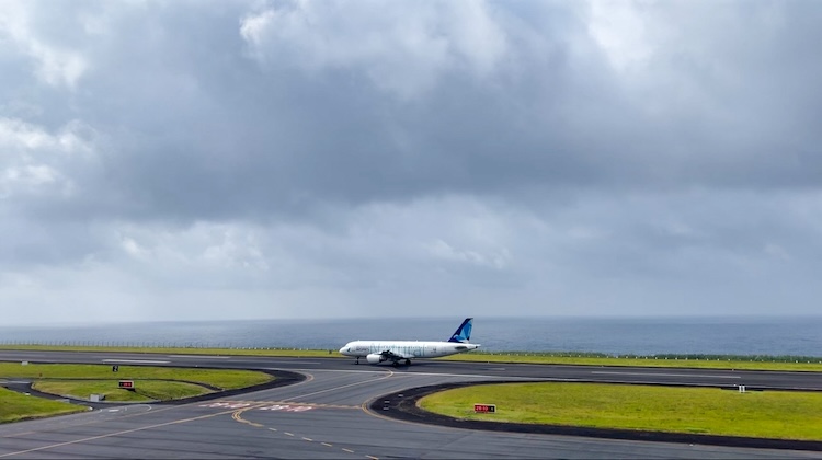 Azores Airlines plane on the runway with the ocean in the background