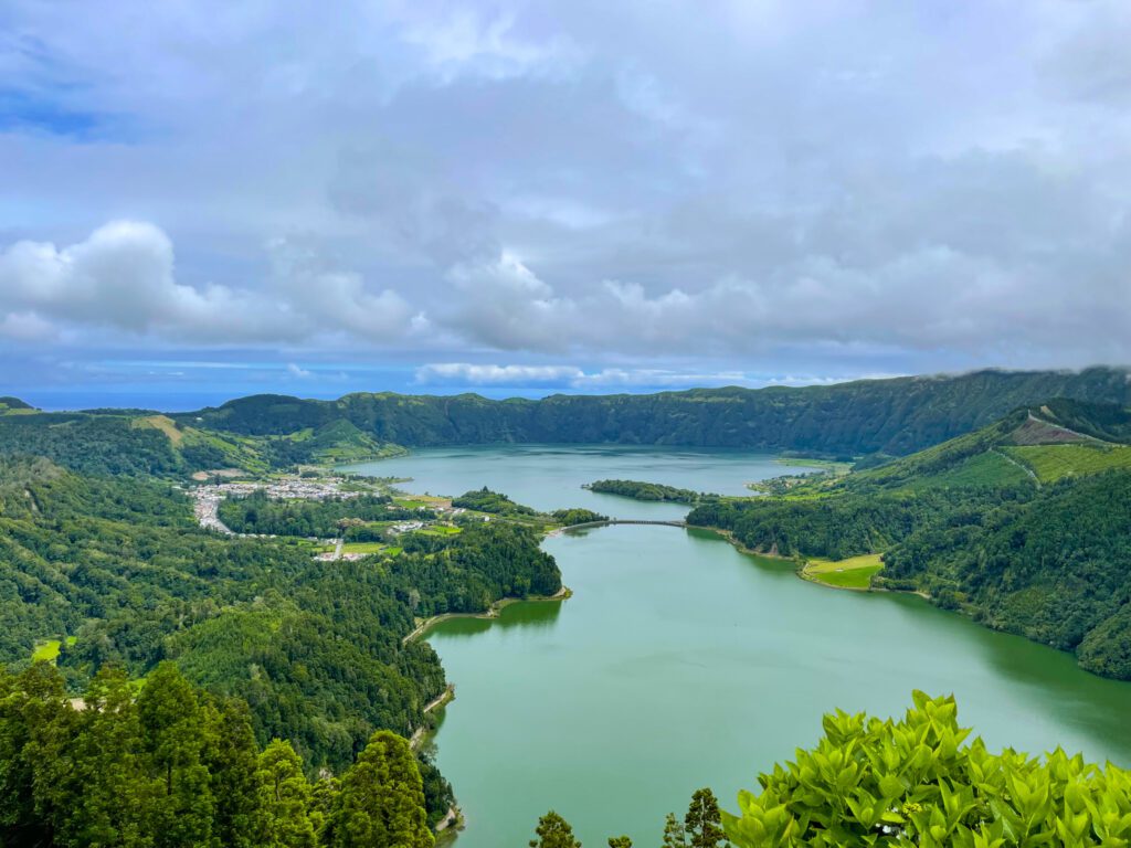 View overlooking Sete Cidades on Sao Miguel island in the Azores. Sete Cidades is two lakes split by a small bridge with a village settled on the left side in between the lakes. 