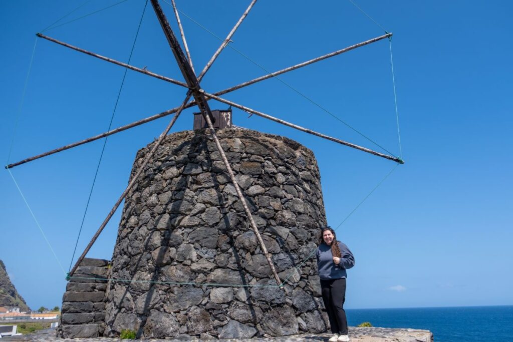 Elaina in front of one of the old stone windmills in Vila do Corvo