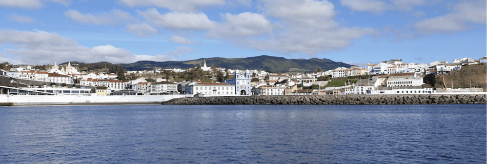 A view of the coast of Terceira island featuring Angra do Herosimo from the water.