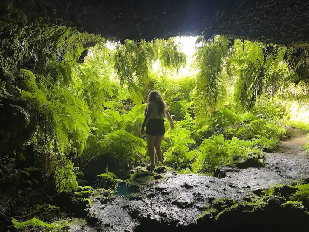 Elaina standing in the entrance of Furna Frei Matias in Pico, Azores