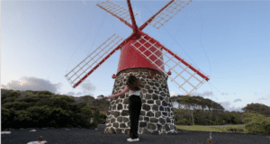 Elaina in front of a red windmill in Pico