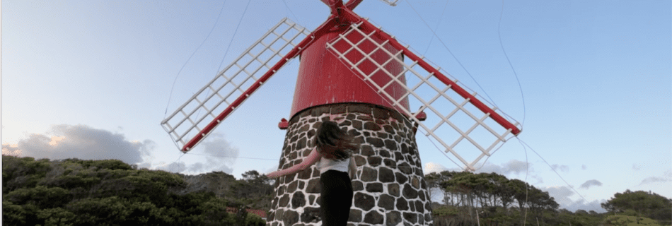 Elaina in front of a red windmill in Pico