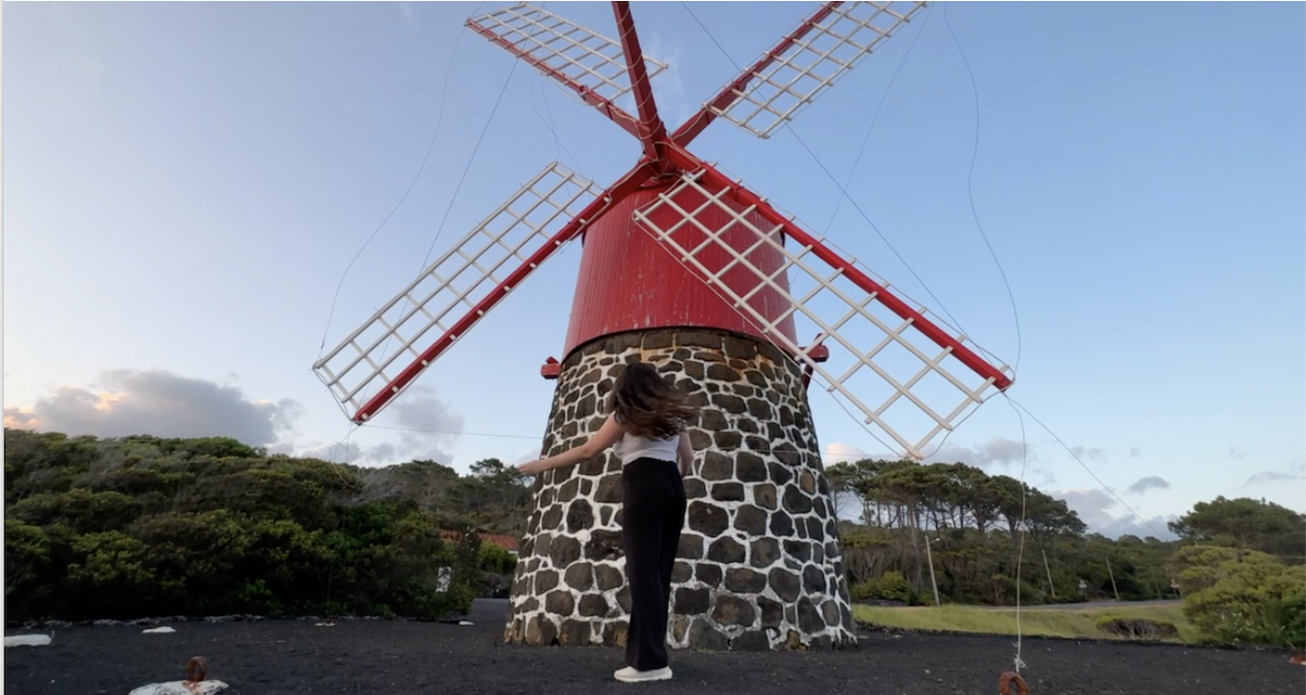 Elaina in front of a red windmill in Pico