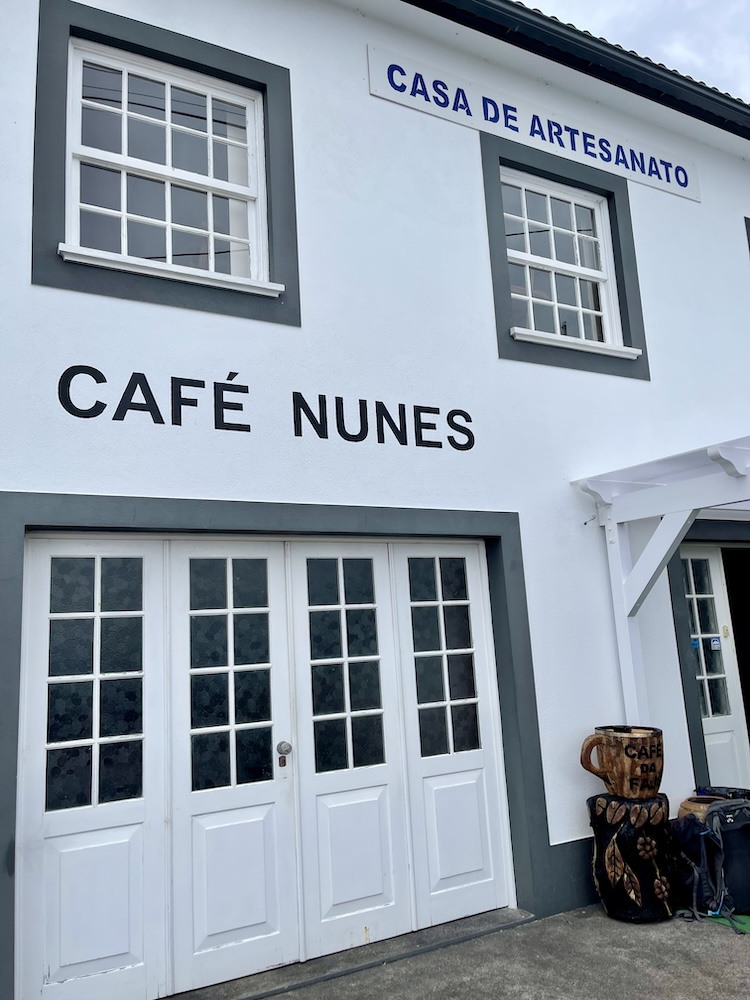 The front of Café Nunes in Fajã dos Vimes, São Jorge, Azores. It has a white facade with windows and a door.